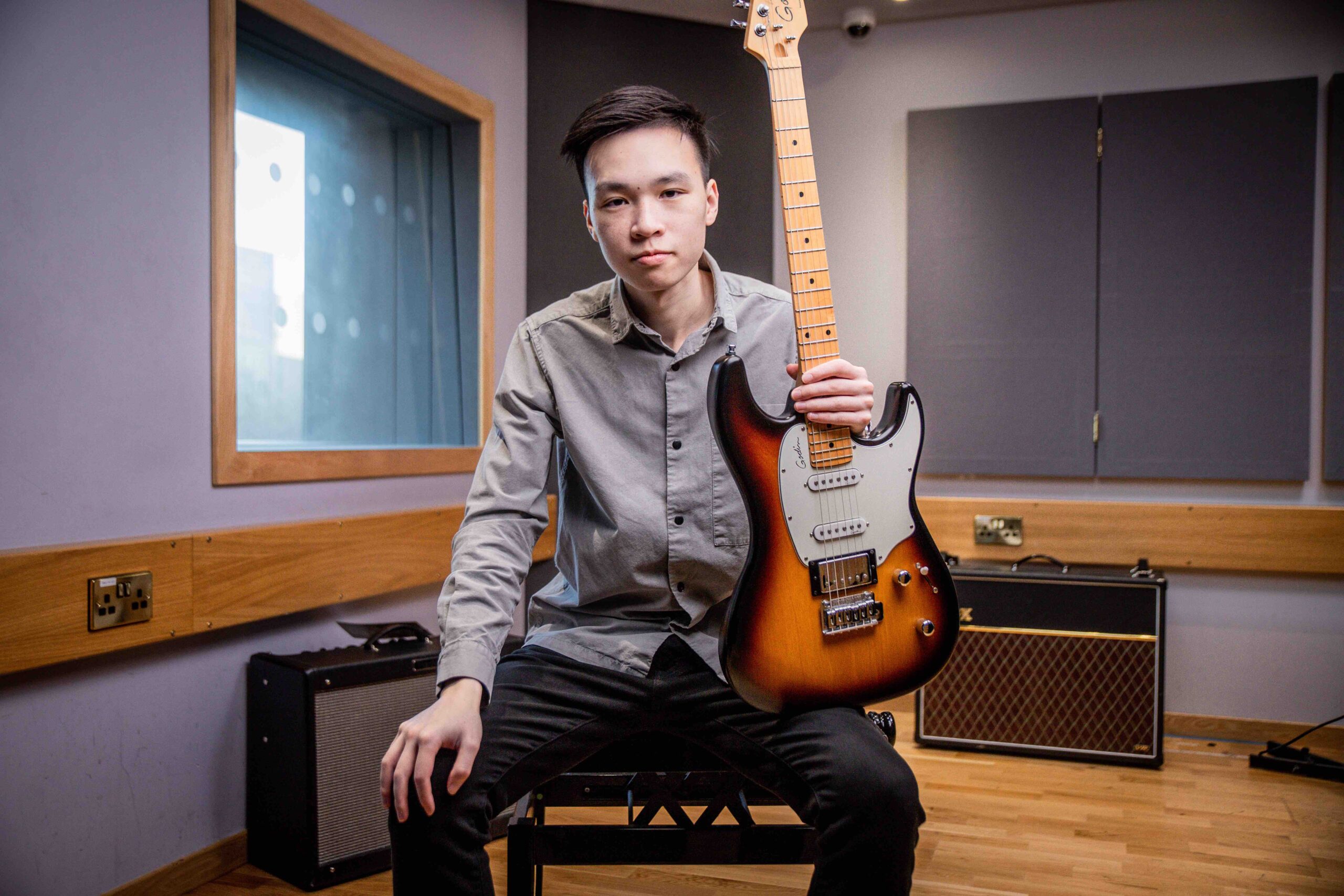 Contact Bryan holding guitar