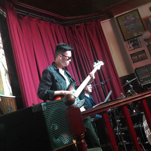 Bryan playing bass guitar